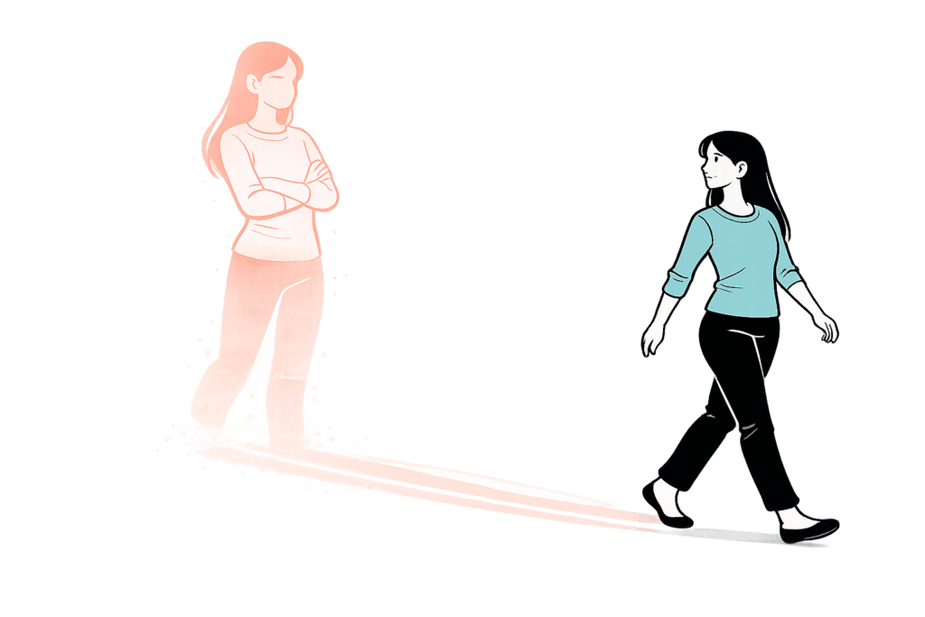 Inner critic in coaching – woman looking at her shadow which appears larger and more critical than she is